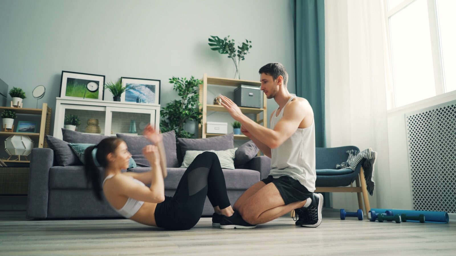 a man and woman sitting on the floor in a living room